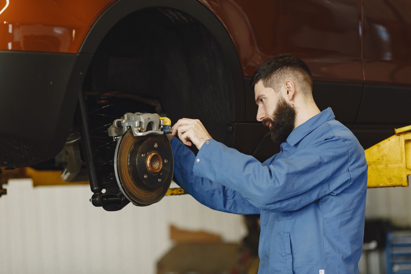 Mechanic servicing a car brake system