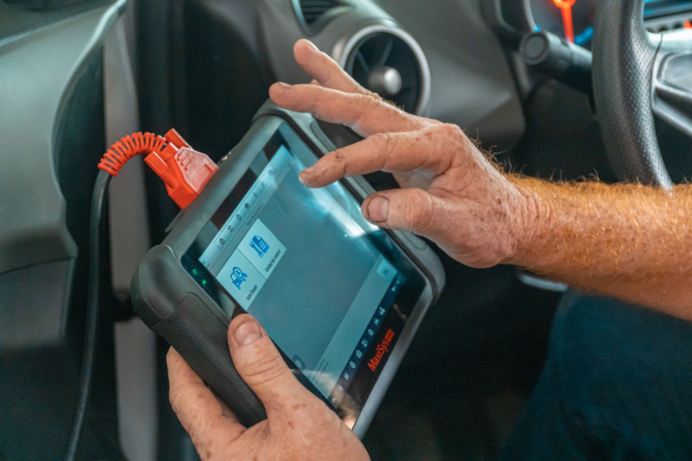 Technician running a computer diagnostic scan